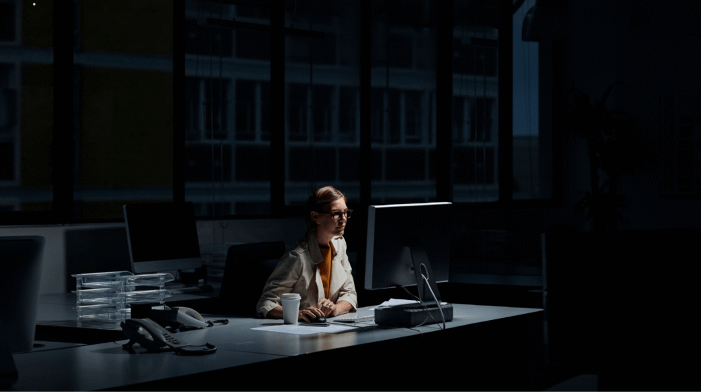 Small business owner burnout — a man reflecting at her desk, representing the moment before transformation.